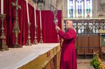 Archbishop holding silver crozier having just taken it off high altar in York Minster