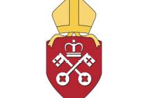 Red shield with white crossed keys and crown with gold mitre above