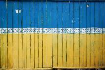 Fence boards painted in colours of Ukrainian flag, blue and yellow