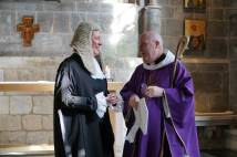Woman dressed in lawyers wig and gown next to Bishop in purple robes and white mitre