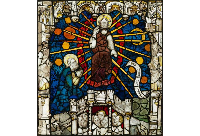 Close up of stained glass window showing God sitting in judgement