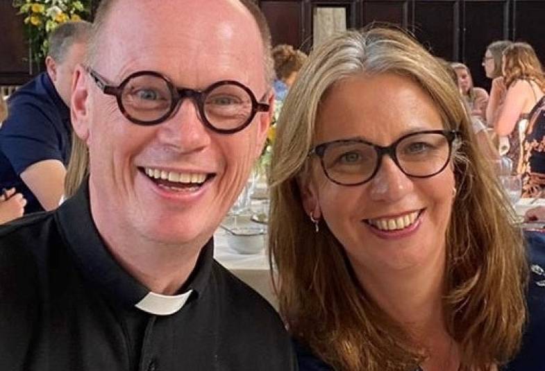 A picture of a man dressed as a vicar next to a woman