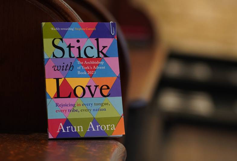 Book entitled Stick with Love propped up on a dark wooden bench