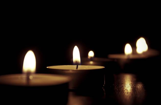 3 lit tealights with black background