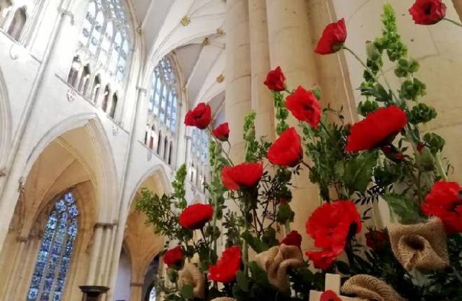 Display of poppies with backdrop of high vaulted ceiling of a church