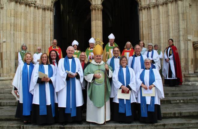 Archbishop Stephen stands with a group of lay ministers on the steps of York Minster